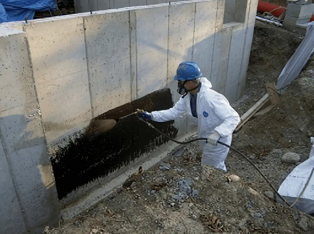 Professional waterproofing the exterior walls of the basement in Bloomington, IN