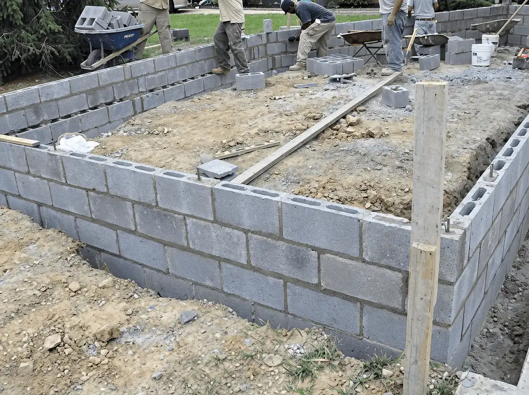 Professionals building a foundation with blocks in Bloomington, IN