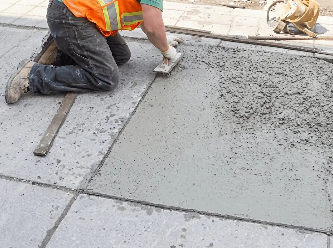 Professional repairing a concrete floor in Bloomington, IN
