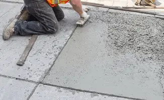 Professional repairing a concrete floor in Bloomington, IN