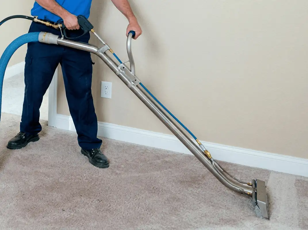 Professional operating a liquid removal machine on a carpeted floor in Bloomington, IN